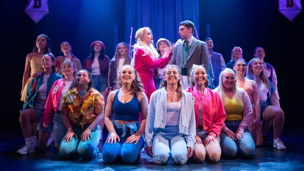 Legally blonde ensemble are assembled on stage
